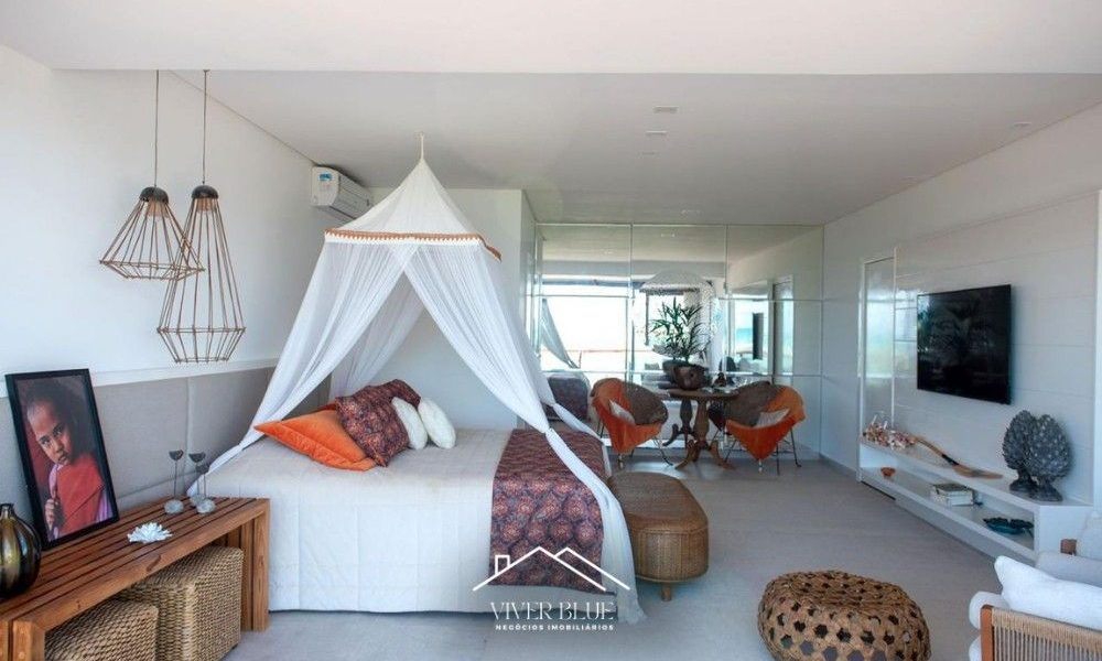 Suíte elegante com decoração clean, cama com dossel e iluminação natural, criando ambiente acolhedor e sofisticado.