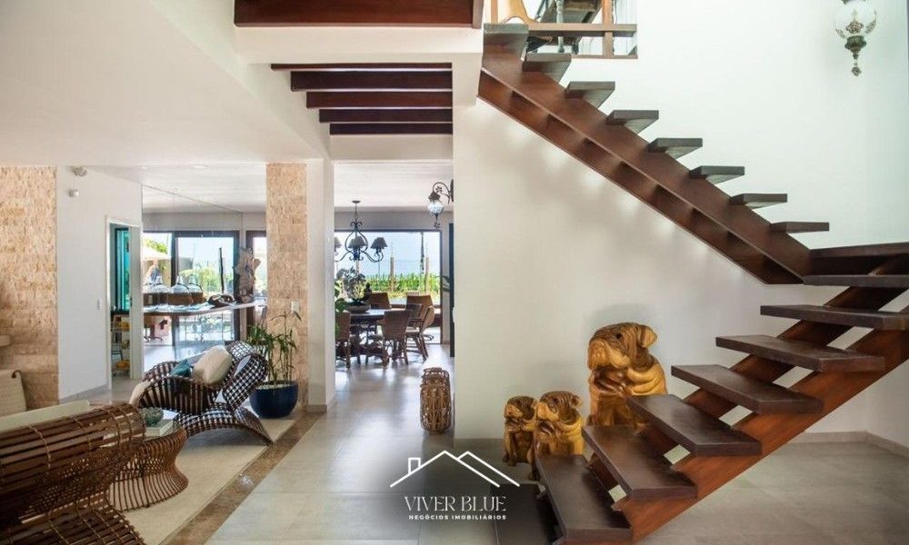 Ambiente interno com escada moderna, integração de espaços e design arquitetônico sofisticado.